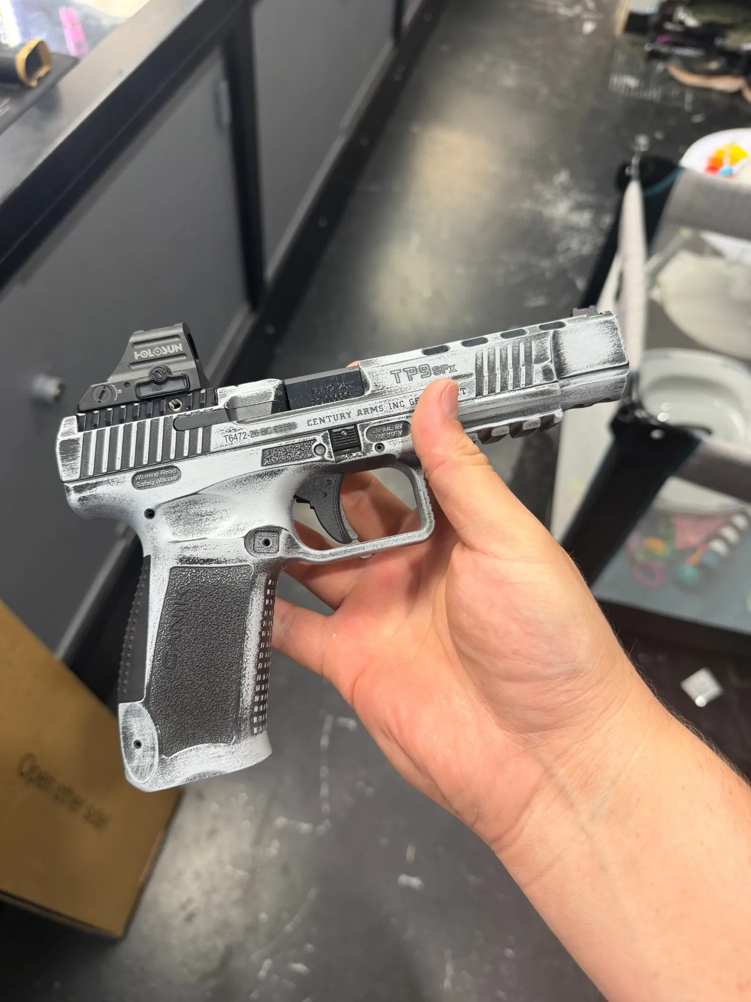 Canik TP9SFx pistol in a distressed white-over-black battleworn Cerakote finish