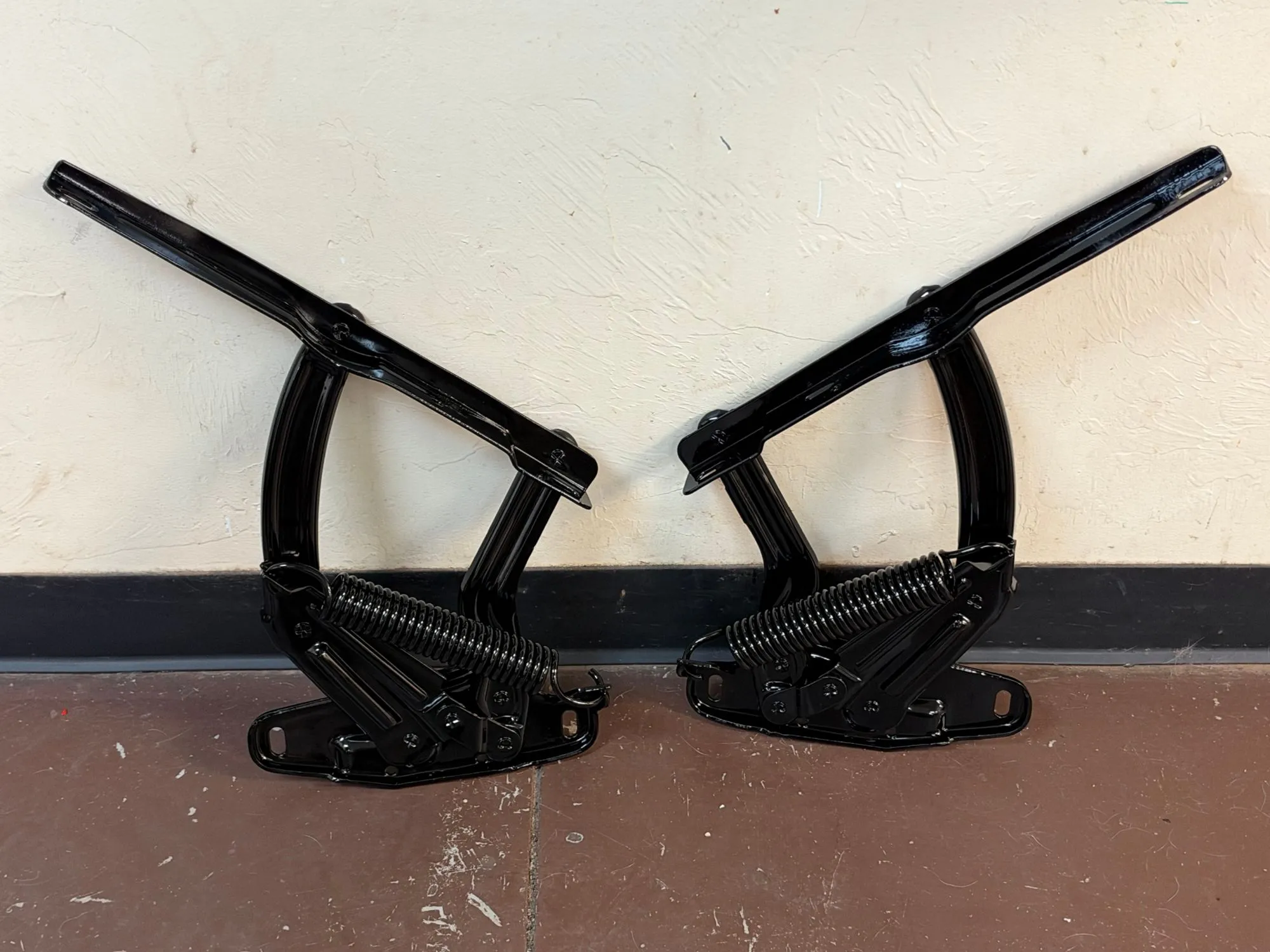 Pair of spring-loaded hood hinges in gloss black powder coat