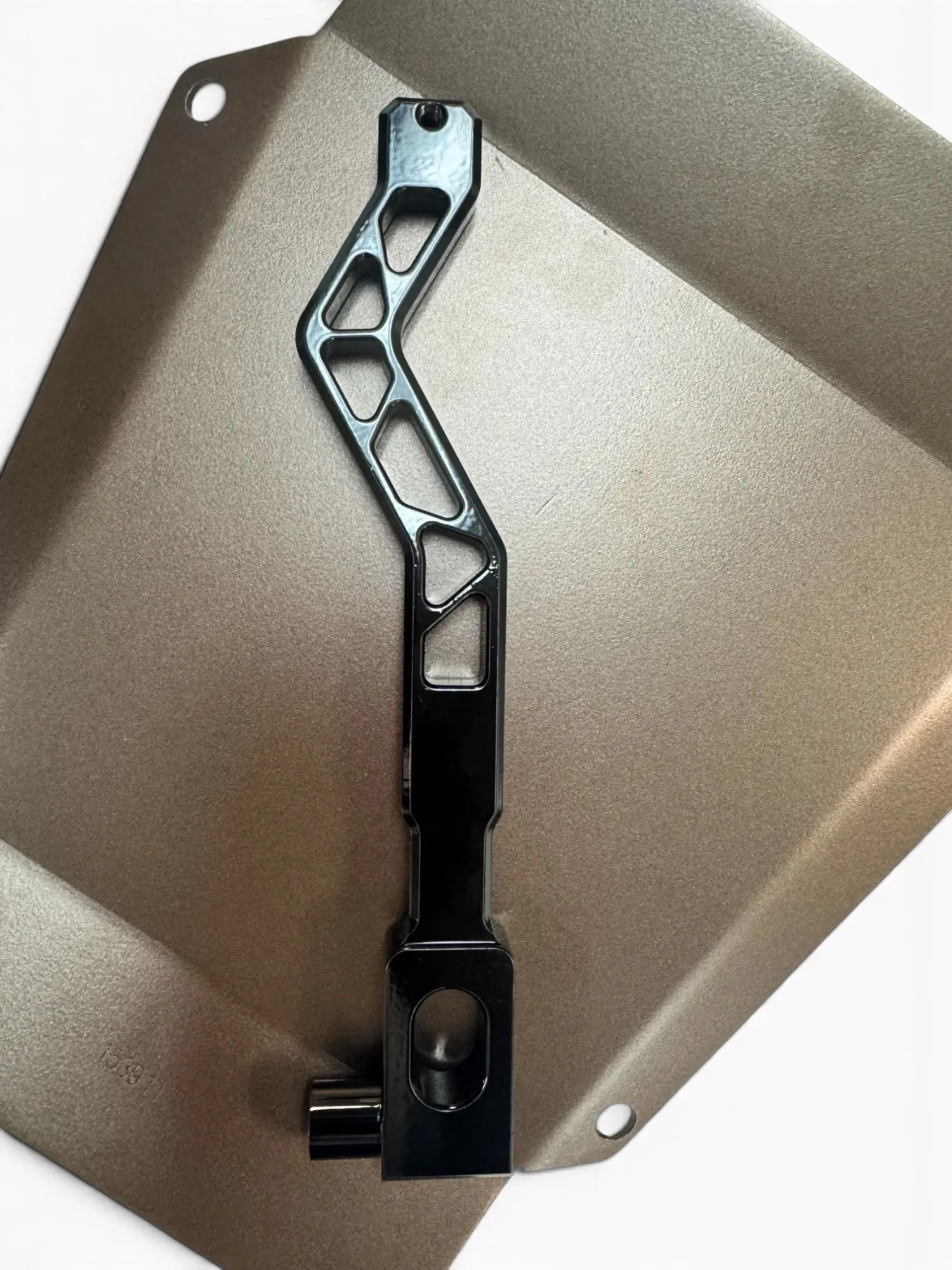 Gloss black powder-coated shift lever on a bronze plate
