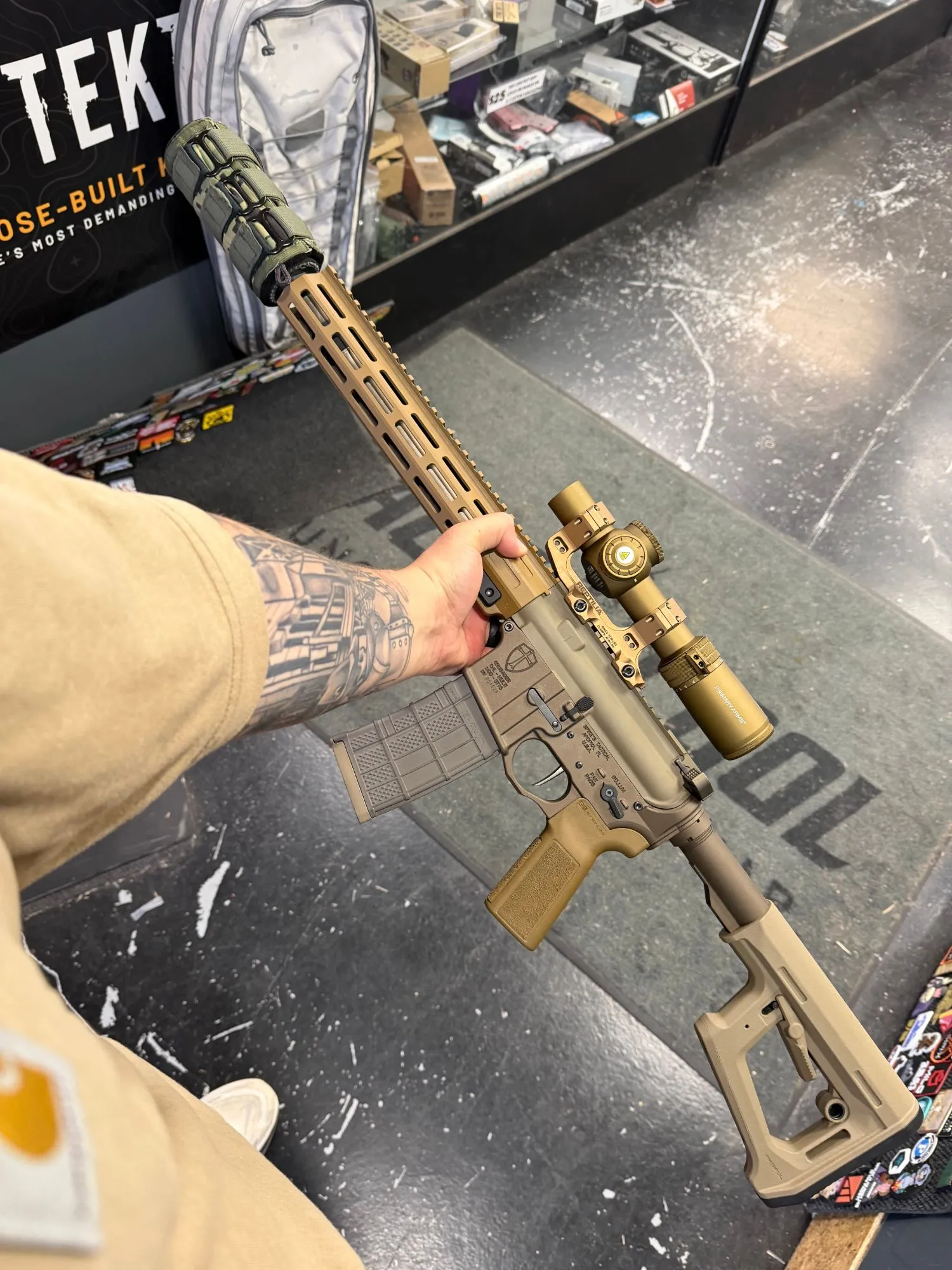 AR-style rifle in bronze and flat dark earth Cerakote with a matching bronze scope