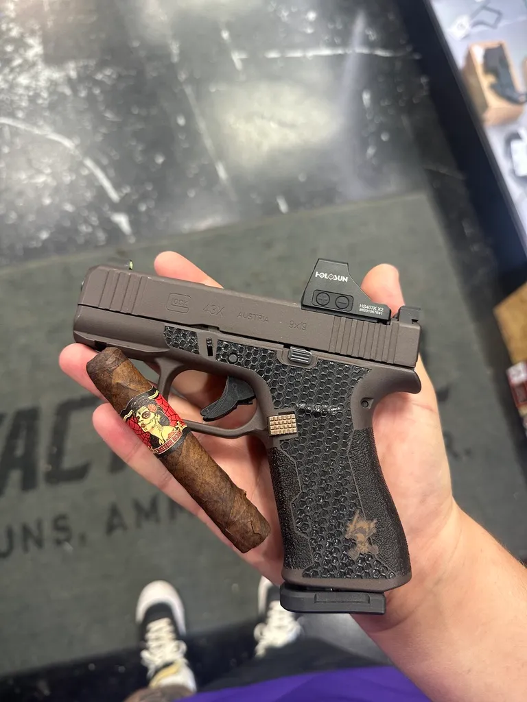 Glock 43X in bronze Cerakote with hex stippling and a red dot